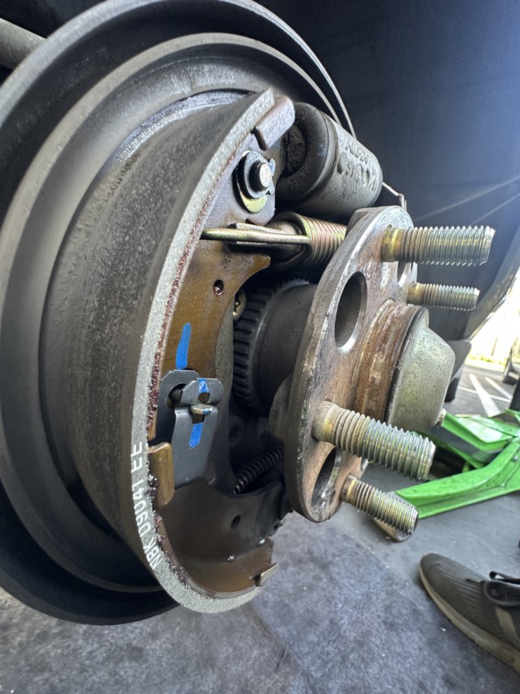 Rear brake shoes marked with blue paint during a mobile brake shoe replacement by EZ-Brakes