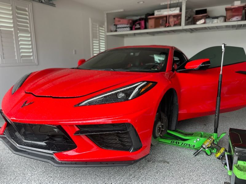 Corvette C8 raised on jack stands during mobile brake service