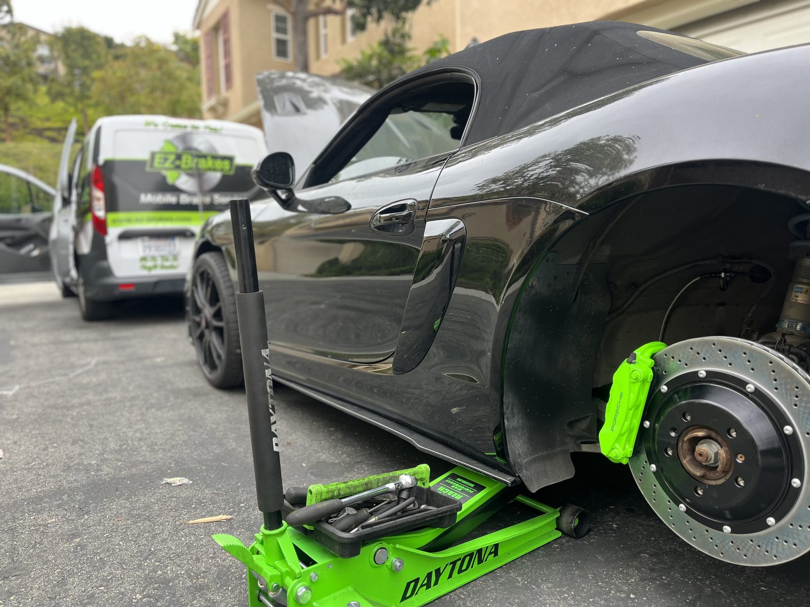 EZ-Brakes mobile technician servicing a Porsche in a driveway