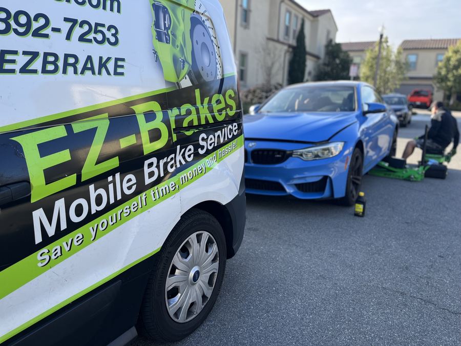 EZ-Brakes van close-up next to a BMW M4 during a mobile brake service