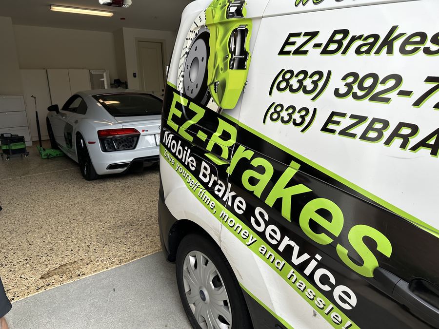 EZ-Brakes van in a garage next to an Audi R8
