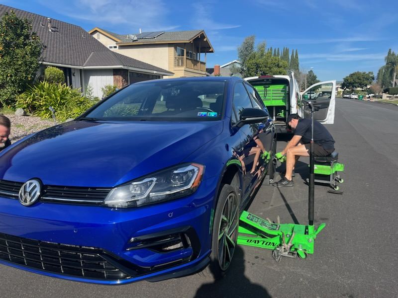 EZ-Brakes van parked behind a VW Golf R during a mobile service call
