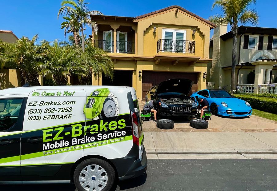 EZ-Brakes van parked in front of a home with two cars serviced in the driveway