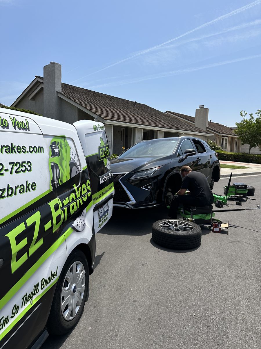 EZ-Brakes van parked next to a black Lexus RX during a mobile brake job