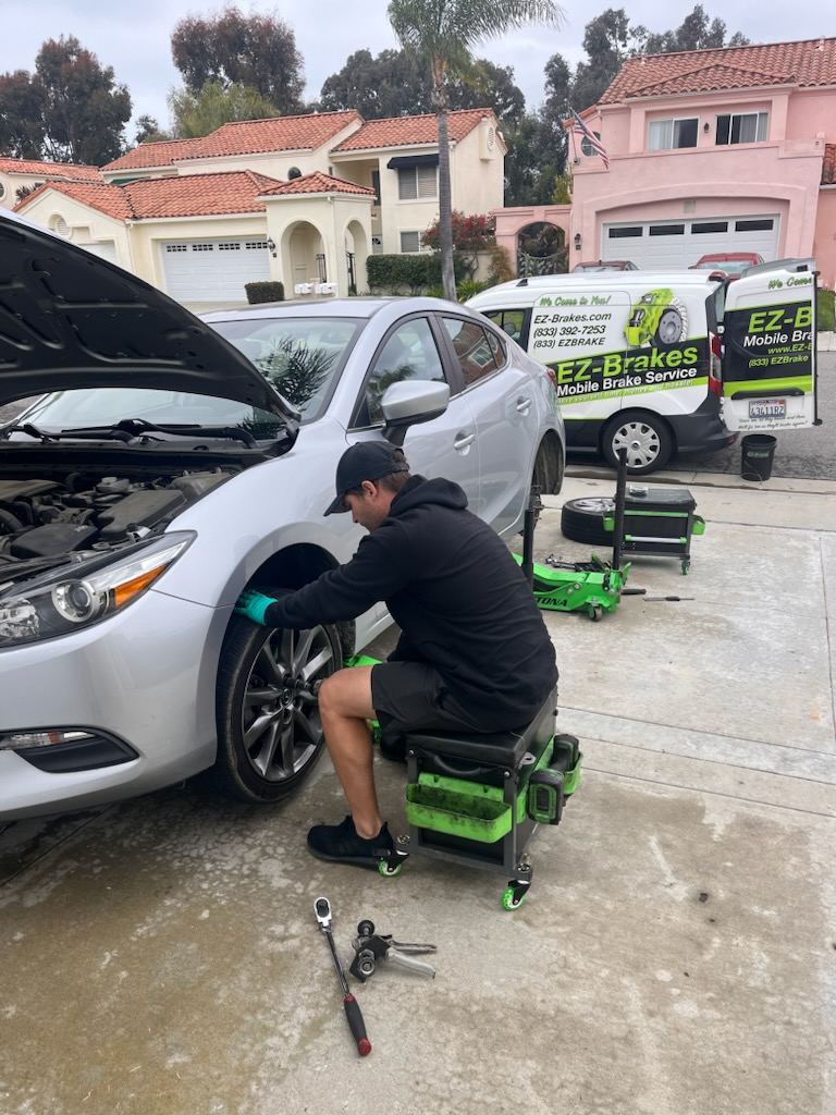 EZ-Brakes van parked next to a car during a mobile brake service call