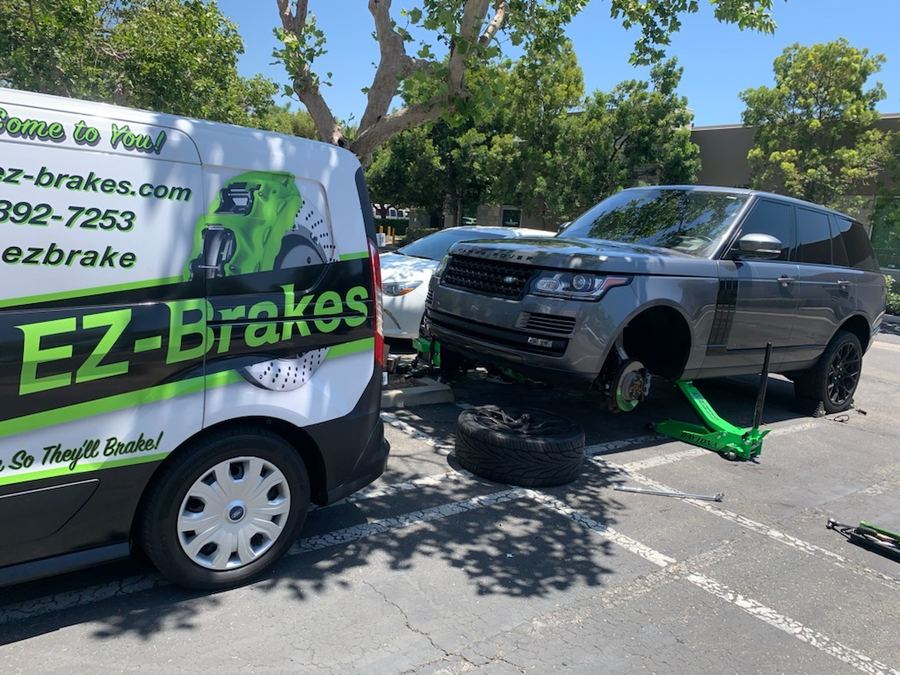 EZ-Brakes van parked next to a silver Range Rover during a mobile brake job