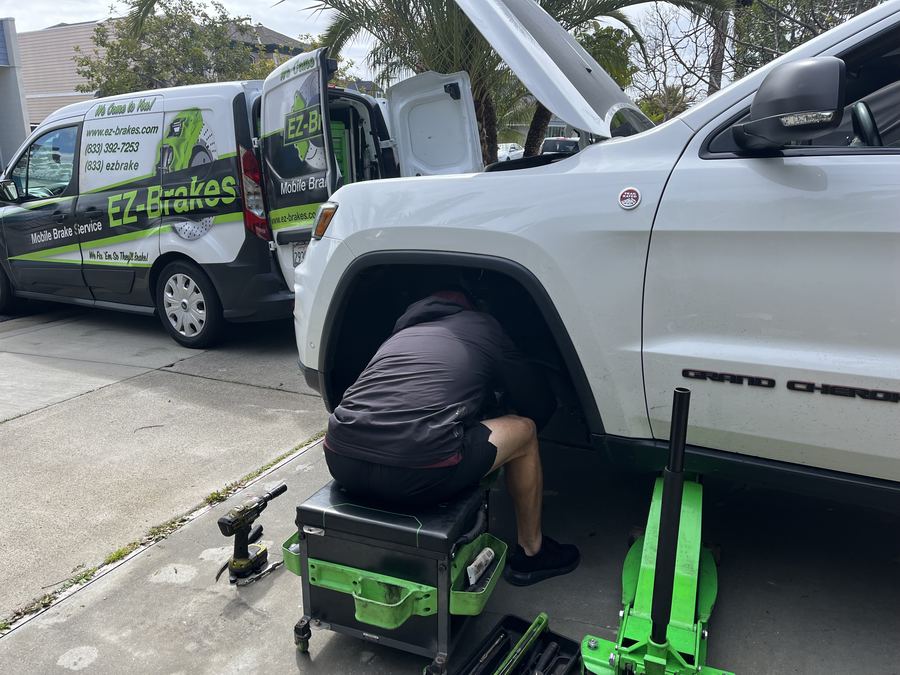 EZ-Brakes van parked next to an SUV during a mobile brake service call