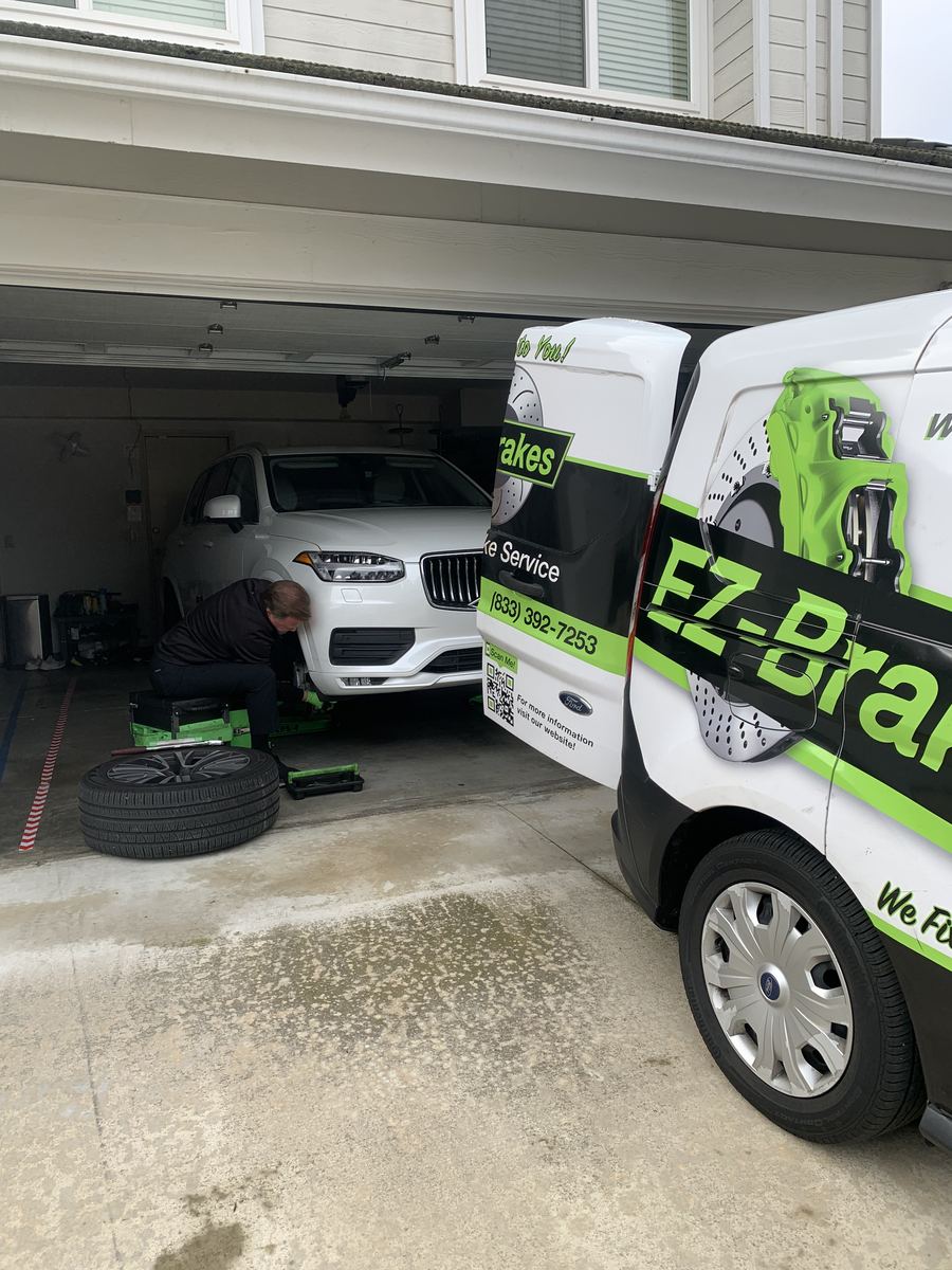 Mobile brake technician servicing a Honda Civic curbside