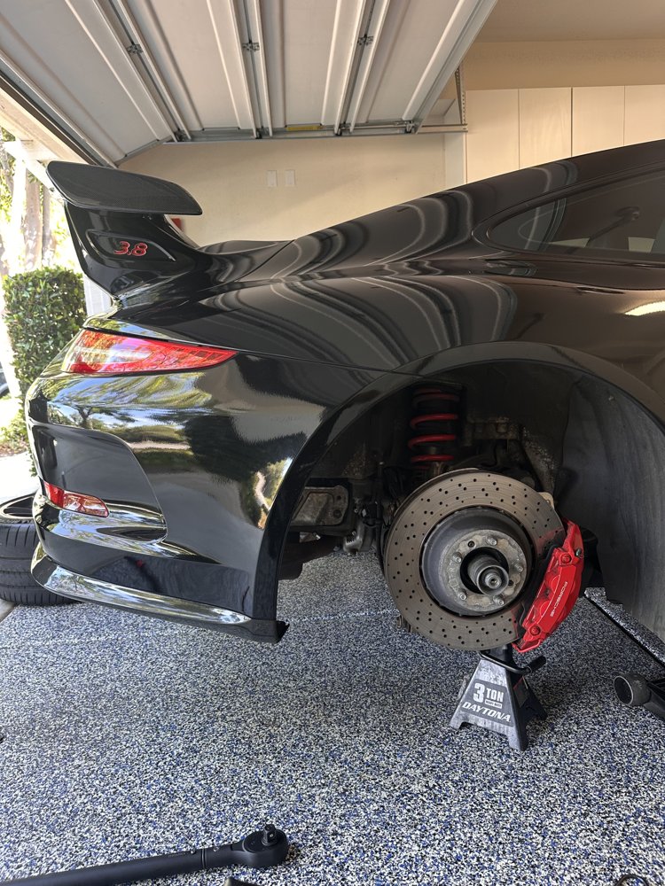 Porsche 911 GT3 rear suspension and brakes visible during a mobile suspension service by EZ-Brakes