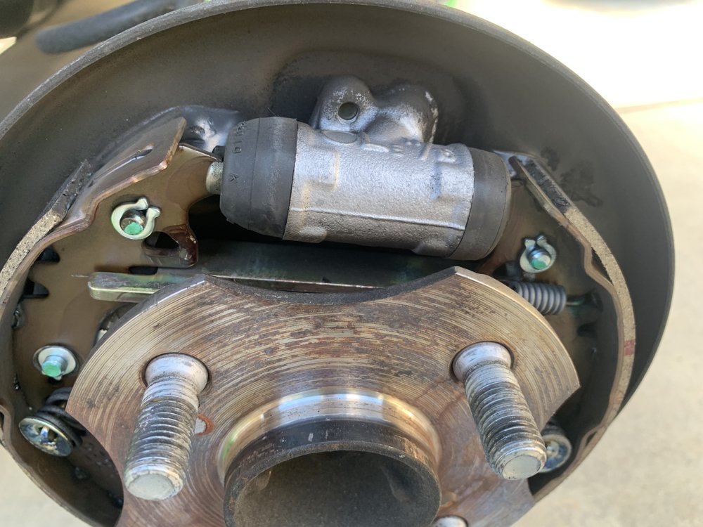 New wheel cylinder and brake shoes installed during a mobile brake drum replacement